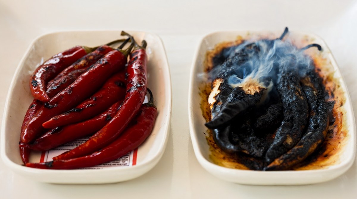 Two dishes of roasted chilli side by side, one deep red and one blackened and charred