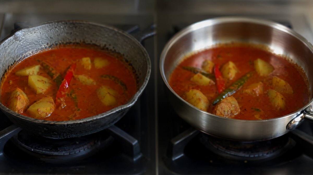 Two pans of the same red coconut curry side by side, one in bare rough cast iron and one in bright sealed stainless steel