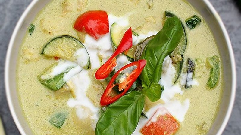 Authentic Thai green curry bowl with chicken and coconut milk